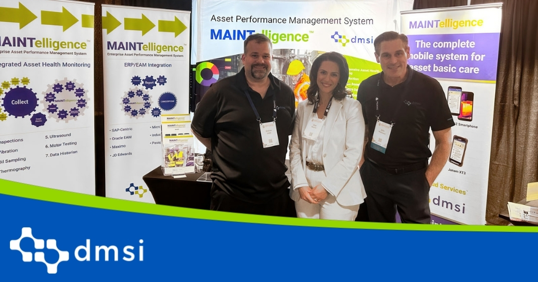 Two men and 1 female standing at a conference booth posing for a picture.