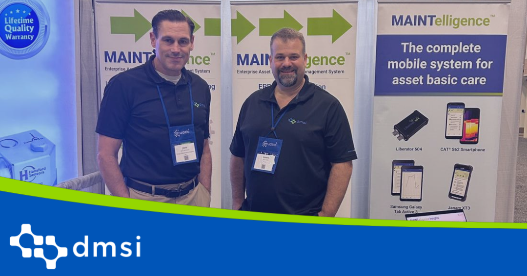Andrew MacSween and John Liddle standing in front of the DMSI booth at SMRP 2025 in Fort Worth Texas