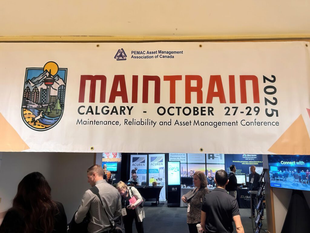 MainTrain 2025 banner hanging by the entrace/exit of the conference room.