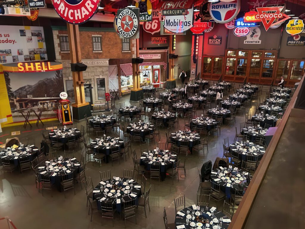 A big ballroom filled with themed tables and chairs for MainTrain 2025 attendees.