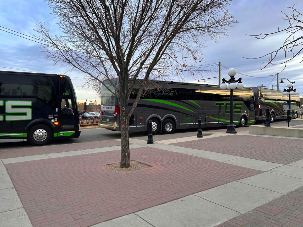 A line of bus in front of the conference venue.